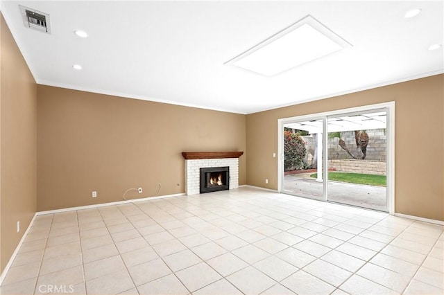 unfurnished living room featuring a skylight, ornamental molding, and light tile patterned flooring