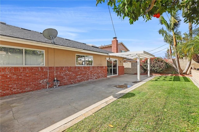 exterior space featuring a yard, a pergola, and a patio area