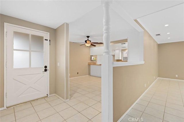 interior space featuring ceiling fan and ornate columns