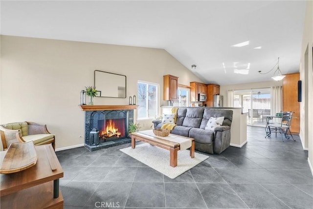 living room with dark tile patterned floors and lofted ceiling