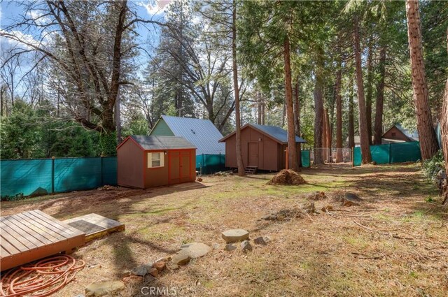 17193 Manzanita St, Stirling City, CA 95978 - view of yard with an outbuilding, a fenced backyard, and a shed