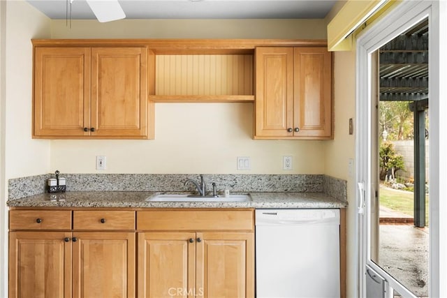 kitchen with white dishwasher, sink, and light stone counters