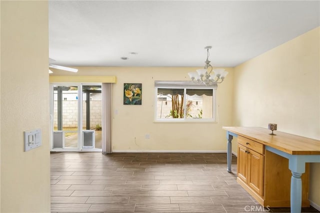 unfurnished dining area with an inviting chandelier