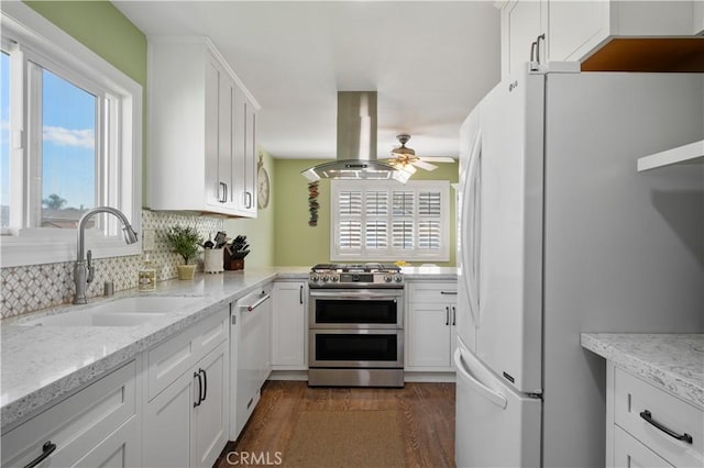 kitchen with sink, white appliances, white cabinets, and island exhaust hood