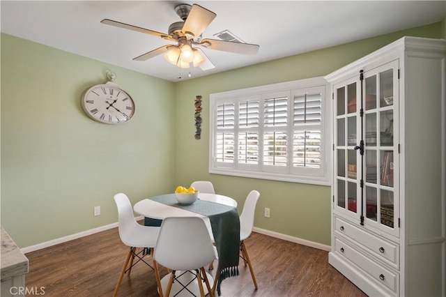 dining space with dark hardwood / wood-style floors and ceiling fan