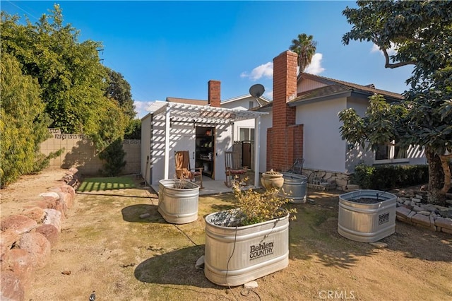 back of property with a pergola