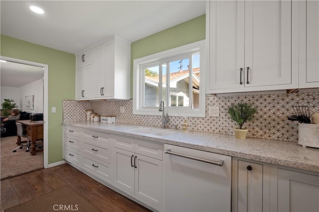 kitchen with white cabinetry, sink, light stone counters, and dishwasher