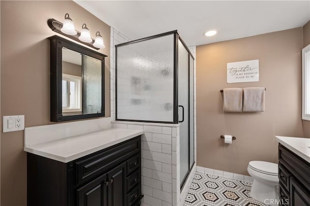 bathroom with vanity, toilet, tile patterned floors, and a shower with shower door