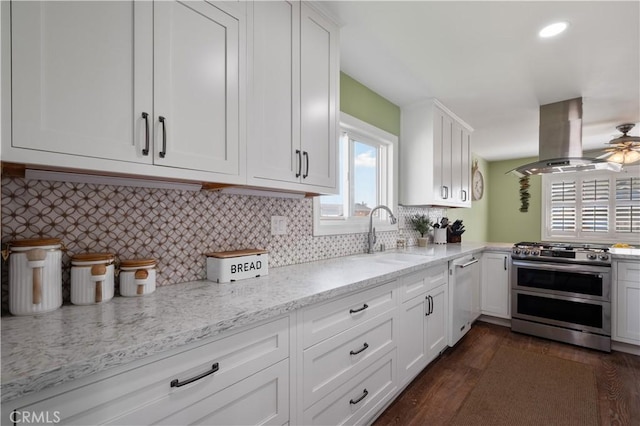 kitchen featuring sink, white cabinetry, white dishwasher, island exhaust hood, and range with two ovens