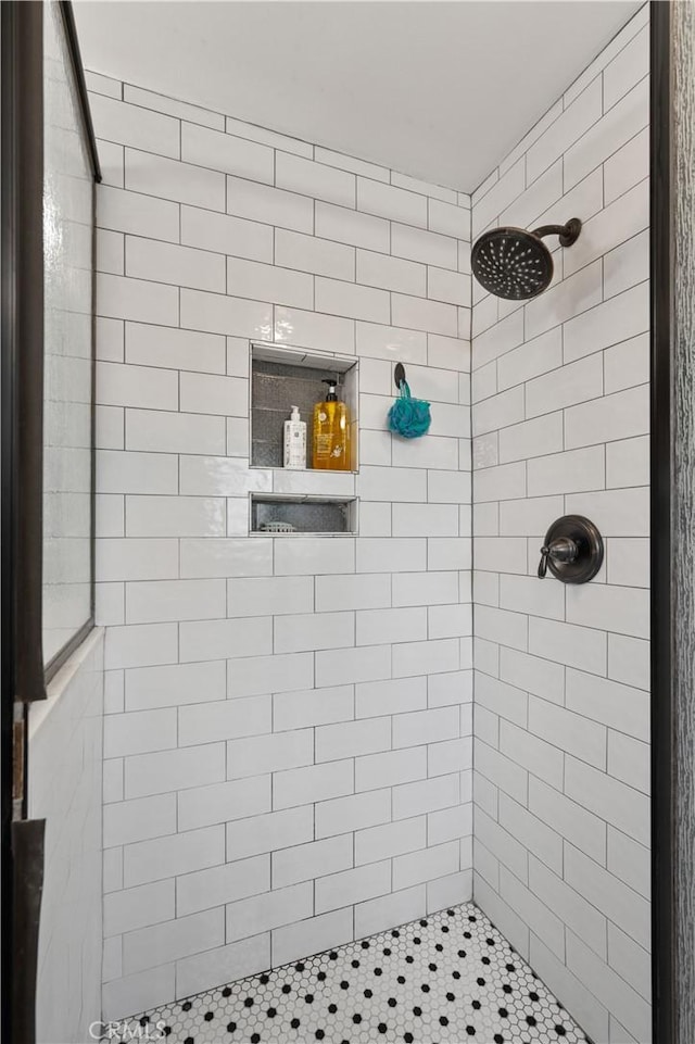 bathroom with a tile shower