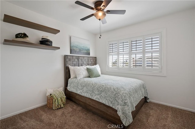 bedroom with ceiling fan and dark carpet