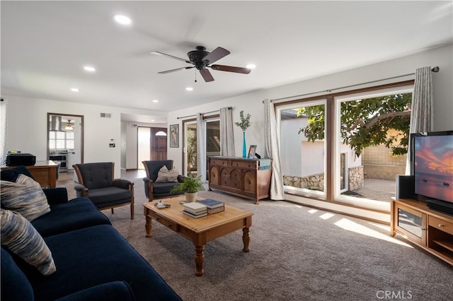 living room with carpet floors and ceiling fan