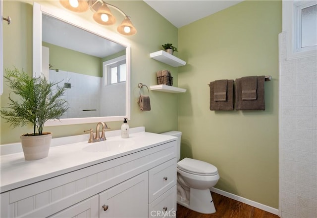 bathroom with vanity, wood-type flooring, toilet, and walk in shower