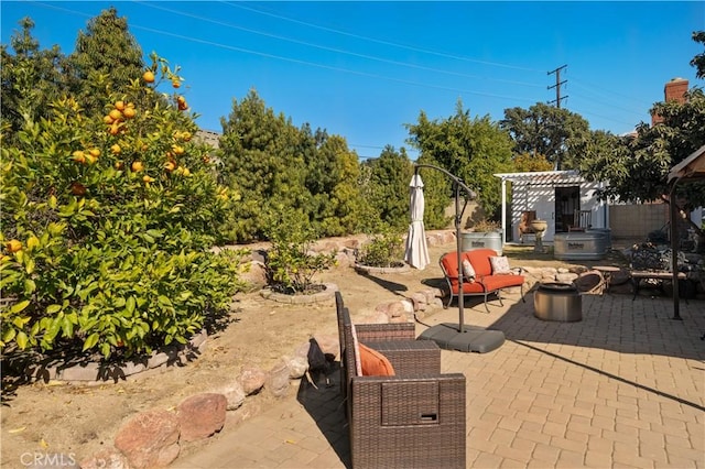 view of patio featuring a pergola and an outdoor living space with a fire pit