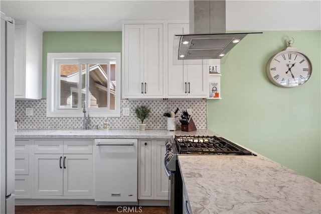 kitchen with white cabinetry, stainless steel gas range oven, sink, and extractor fan