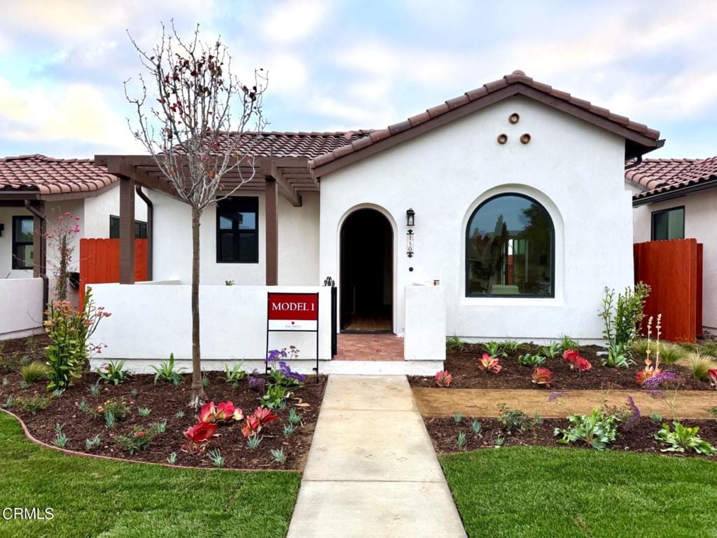 mediterranean / spanish-style house with a front lawn