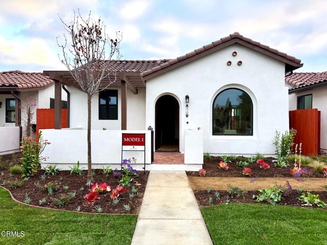 mediterranean / spanish-style house with a front lawn