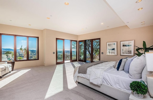 bedroom with access to outside and light carpet