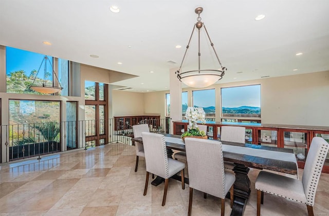 dining space with a mountain view and a healthy amount of sunlight