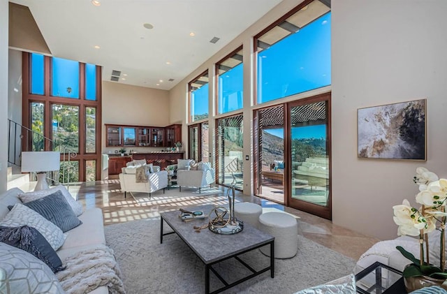 living room with a healthy amount of sunlight and a high ceiling