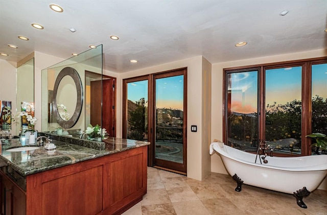 bathroom with vanity and a bathtub