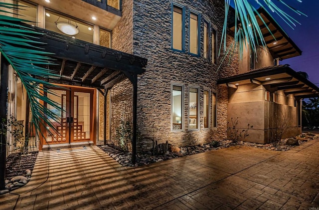 doorway to property with a pergola and a patio area