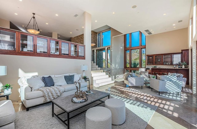 living room featuring a towering ceiling