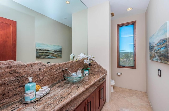 bathroom with vanity, tile patterned floors, and toilet