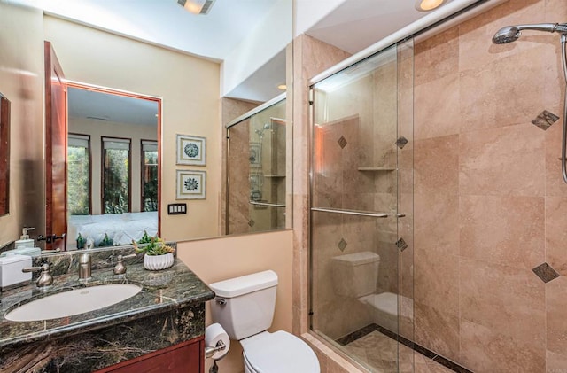 bathroom with vanity, toilet, and an enclosed shower