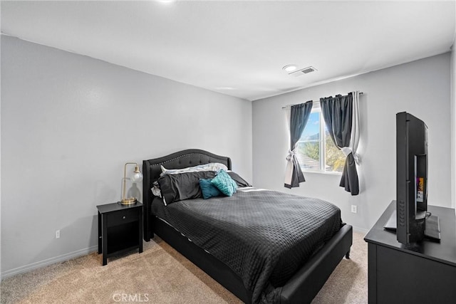 bedroom with visible vents, baseboards, and light colored carpet