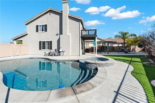 view of swimming pool with a patio, a fenced backyard, and a pool with connected hot tub