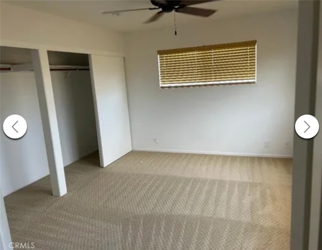 unfurnished bedroom featuring multiple closets, carpet, and ceiling fan