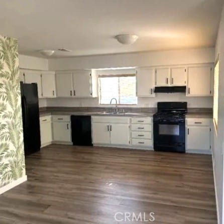 kitchen with white cabinets, dark hardwood / wood-style flooring, sink, and black appliances