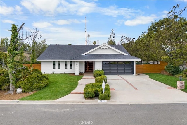 view of front of home with fence, concrete driveway, a front yard, a shingled roof, and a garage