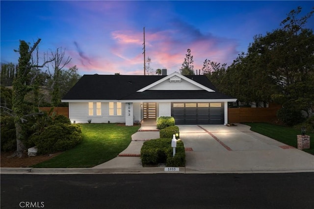 ranch-style house with a yard and a garage