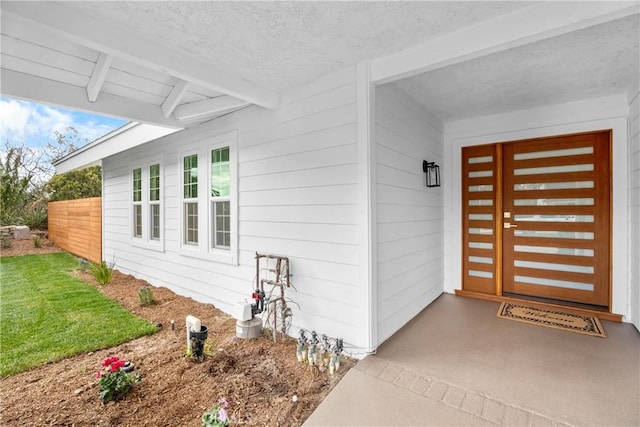 entrance to property with a lawn