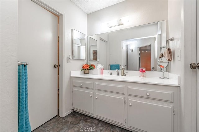 bathroom featuring vanity and a textured ceiling