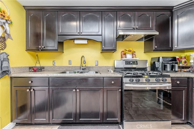 kitchen featuring sink, stainless steel range with gas stovetop, and dark brown cabinetry