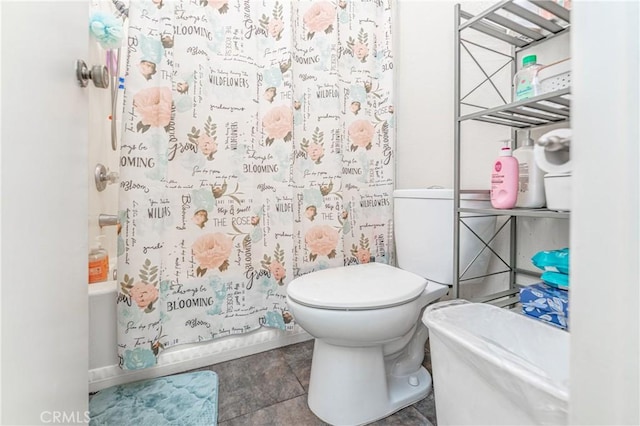 bathroom featuring shower / bath combination with curtain and toilet