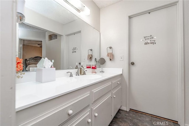 bathroom featuring vanity and a textured ceiling