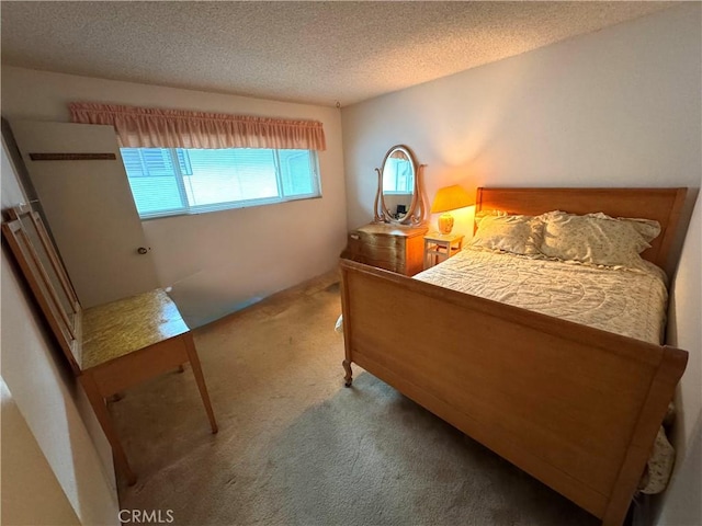 carpeted bedroom featuring a textured ceiling