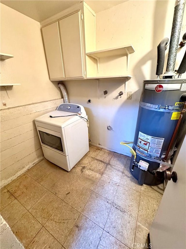 laundry room featuring washer / clothes dryer, secured water heater, and cabinets