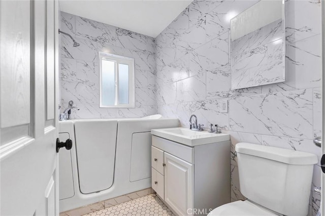 bathroom featuring vanity, a bathing tub, tile walls, and toilet