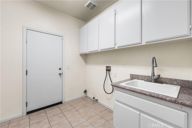 laundry room featuring cabinets, hookup for a washing machine, sink, and light tile patterned floors