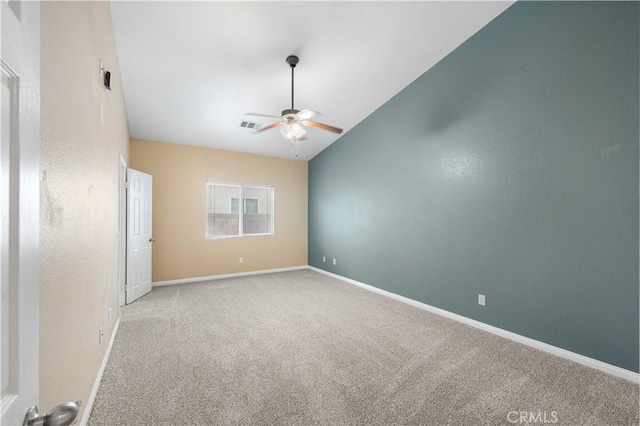 carpeted spare room with lofted ceiling and ceiling fan