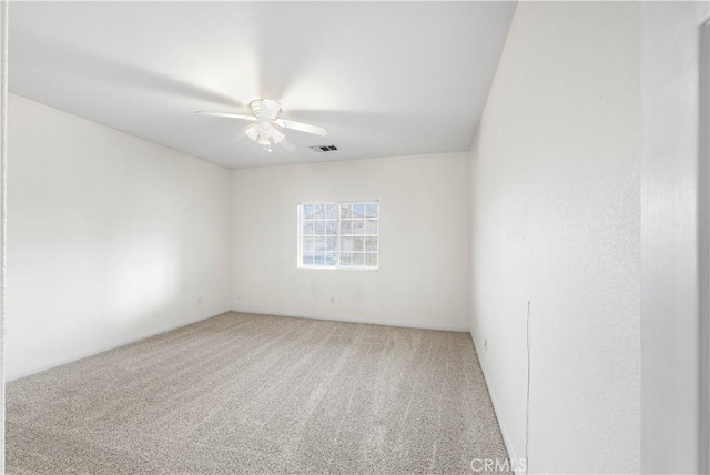 unfurnished room featuring carpet and ceiling fan