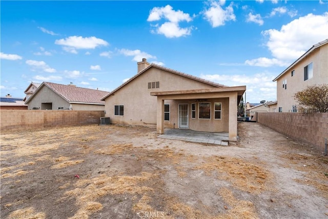 rear view of property featuring a patio and central air condition unit