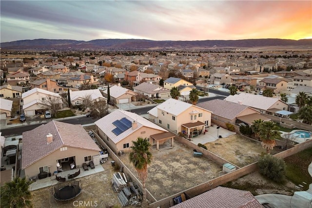 aerial view at dusk featuring a mountain view