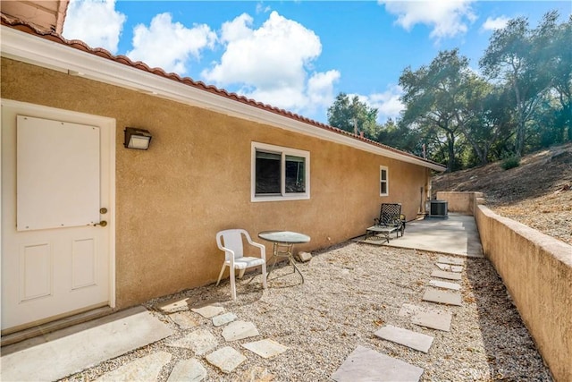 view of side of home featuring central AC and a patio