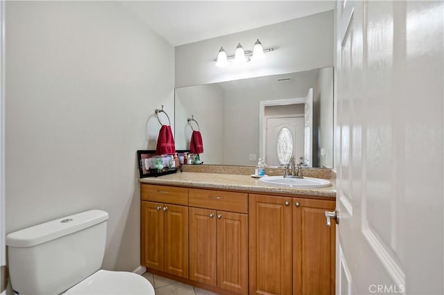 bathroom with tile patterned floors, vanity, and toilet